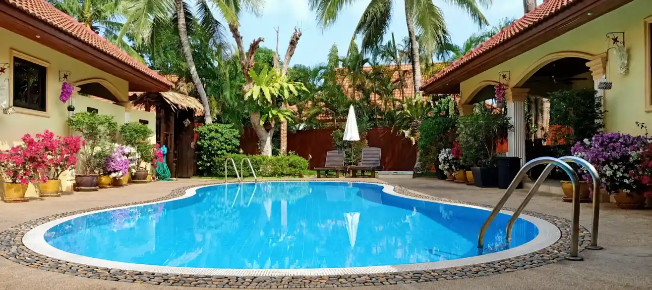 The Coconuts Villa pool lit at night